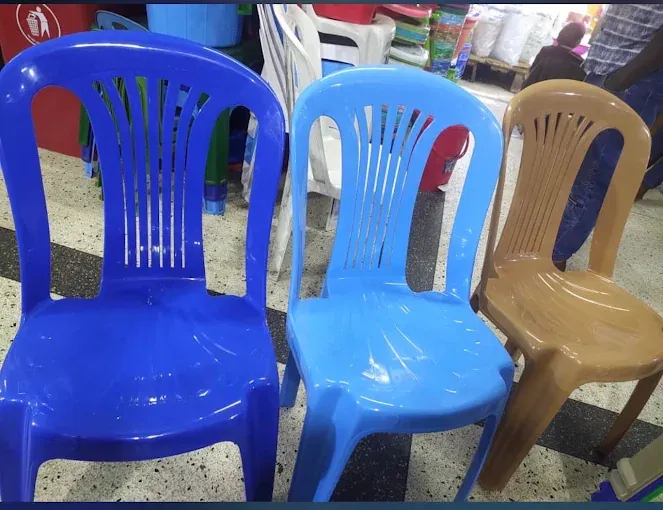 Blue, light-blue and brown plastic chairs on sale at Des fair shop, Arua Park, Kampala