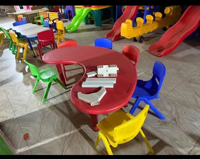 Red children’s plastic table and colourful play chairs at Des fair shop, Arua Park, Kampala