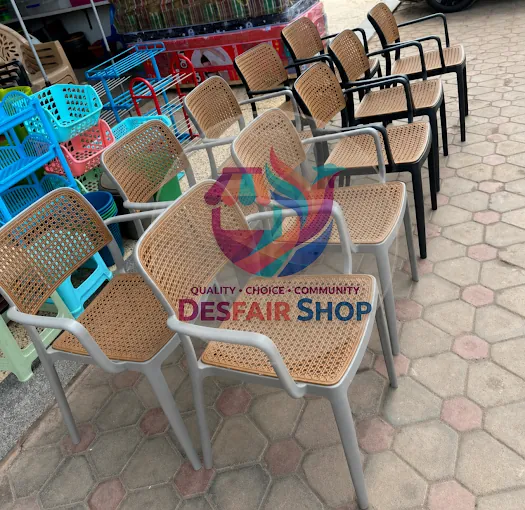 Rows of tan woven-look plastic armchairs with grey and black frames